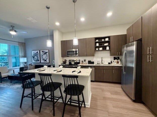 Integra Palms: Explore a stylish kitchen and living space perfect for modern living. - Integra Palms Apartments
