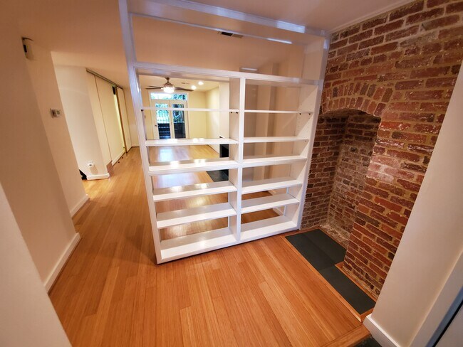 Entrance and spacious living room with bamboo floors and fireplace, built in bookshelves and entryway - 2506 Cliffbourne Pl NW Unit APT B
