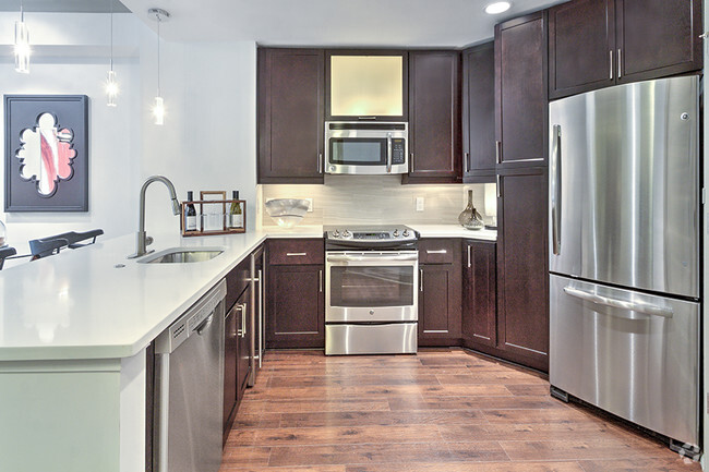 Kitchens with Quartz countertops and stainless steel appliances - The Encore SouthPark Rental