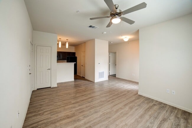 Spacious Living Area with Ceiling Fan - Grand Station Apartment Homes