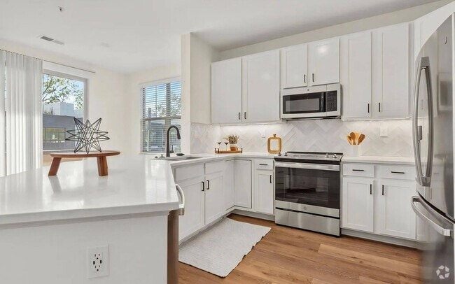 Spacious Kitchen with White Cabinets and Premium Fixtures - The Maggie Rental