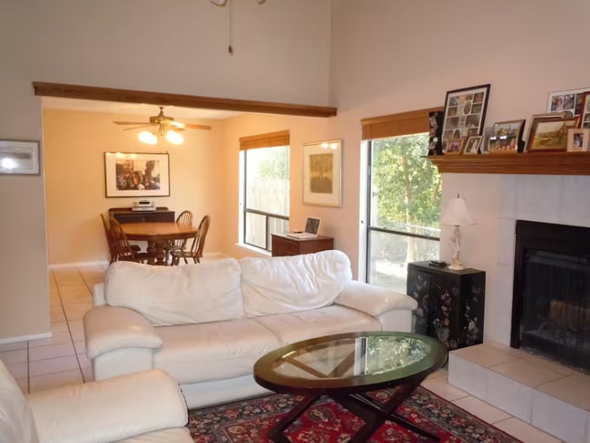 Living room has high ceiling with tons of natural light, gas fireplace, built-in bookcase - 6806 Thorncliffe Dr Rental