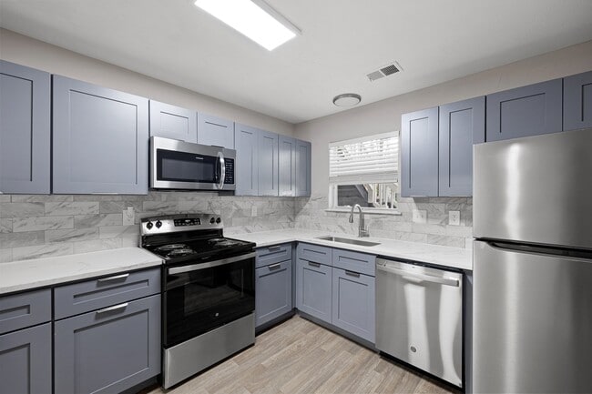 Kitchen with Stainless Steel Appliances and Granite Countertops - Manchester at Mansell