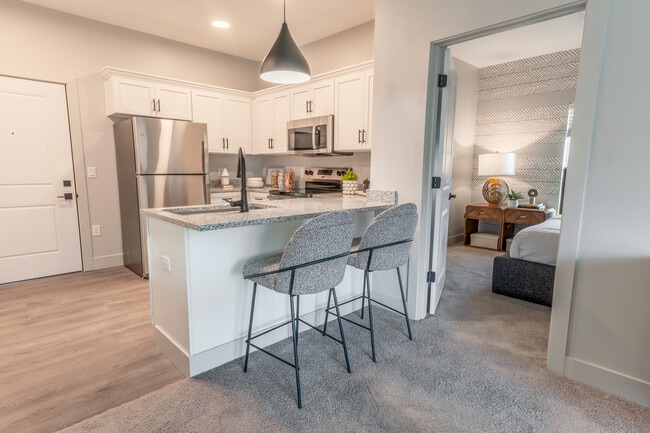 Step into sleek sophistication with this stylish apartment kitchen, perfect for culinary creations and cozy dining.