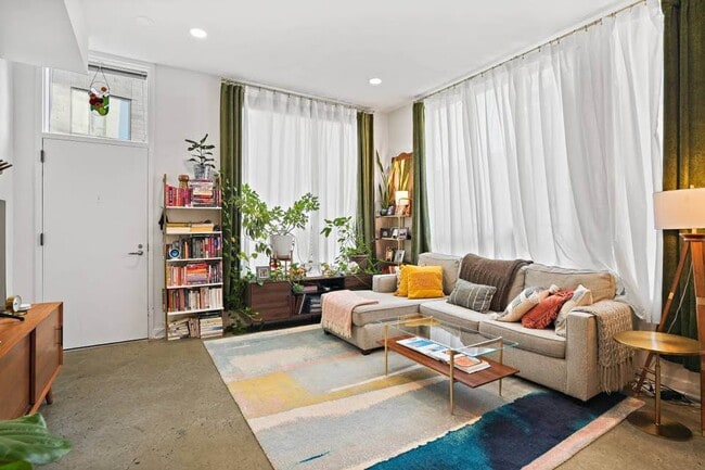 Ceiling-high windows allow for streaming sunlight. - 1414 Belmont St NW Unit 101