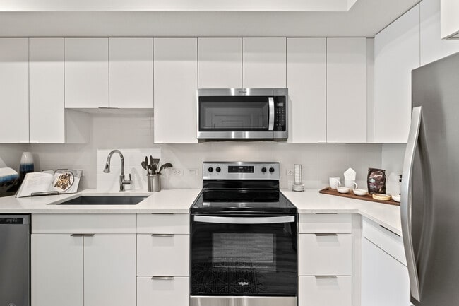 East Phase Kitchen with white cabinetry, white countertops, and stainless steel appliances