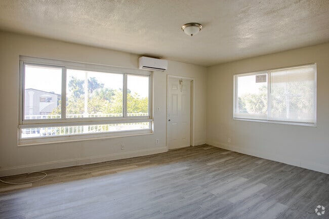 Living Room with Abundant Natural Light - Riverland Court Apartments