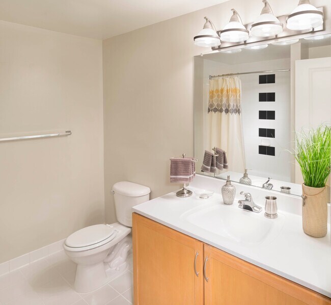 Bath with white countertop and tiled tub