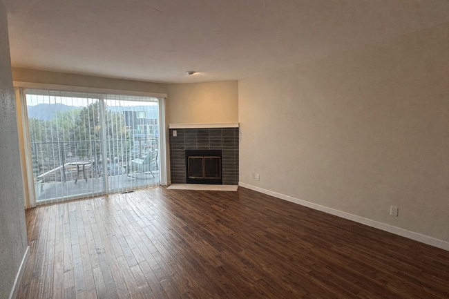 Open living space with a classic wood-burning fireplace. - 524 Superior St