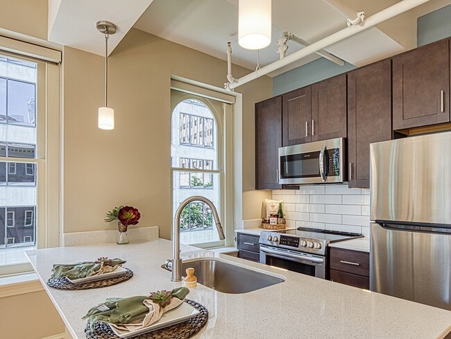 Kitchen islands and stainless appliances - Stumpf Flats on Main Apartments