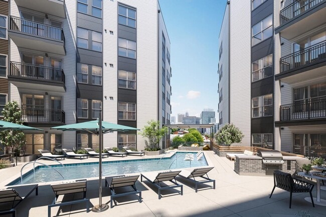 Resort-style pool with spacious sundeck and views of Midtown skyline. - Modera Westside Trail