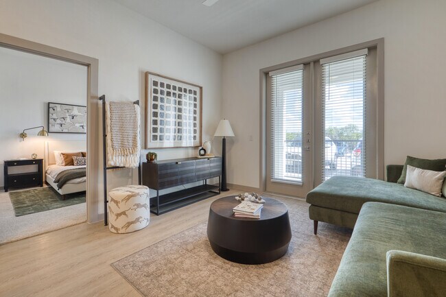 Bright living room with a ceiling fan and patio or balcony access at Residence at Pearsall Park
