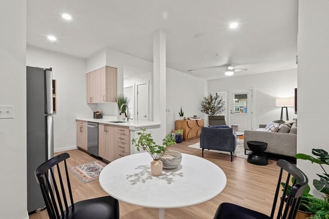Indulge in the elegance of wood plank-style flooring, offering spacious rooms that effortlessly accommodate all your needs, including a dedicated dining area as seen in this 2-bedroom apartment.