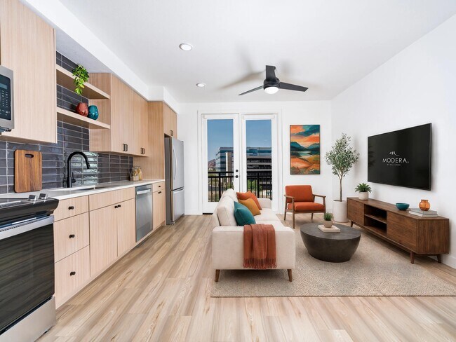 Premium finish home with wood-style flooring, designer cabinetry, stainless steel appliances, and a bright open layout extending to a private balcony. - Modera Rio Salado