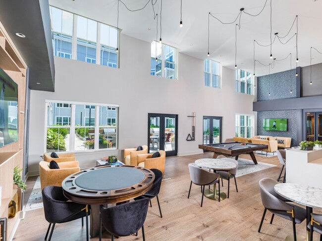 Unwind and entertain at Modera Montville's stylish clubroom, featuring a poker table, pool table, and multiple TVs. It's the perfect spot for game nights and social gatherings!
