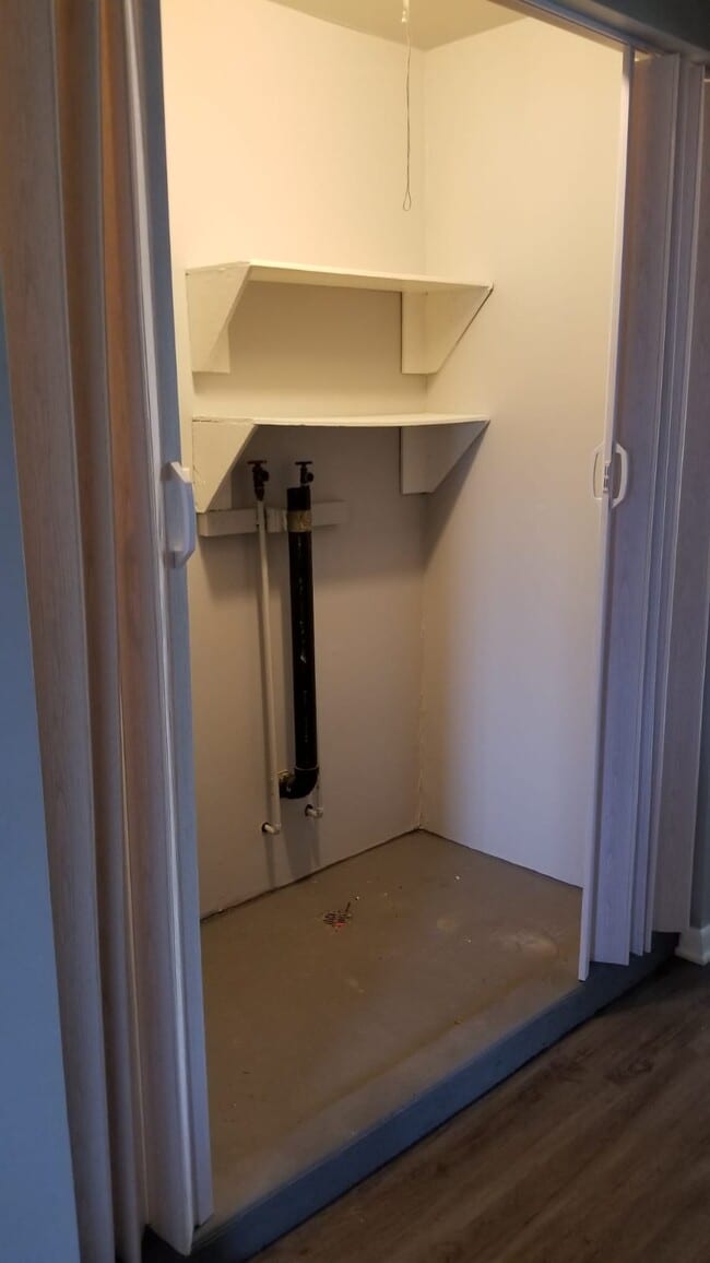 Laundry area neatly hidden away behind curtain.