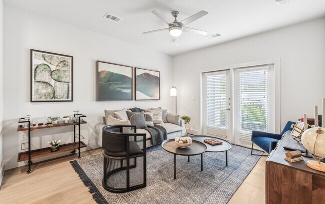 Your Living Room: Hardwood floors and balcony access - Rushcreek at Star Ranch