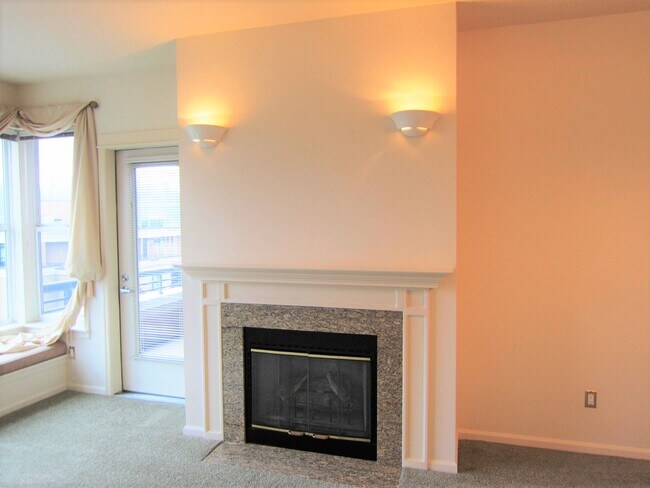 Large living room with electronic fireplace - 10042 Main St Unit 405-Lakeview