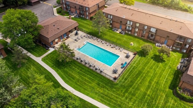 Expansive green space and heated pool at Drawbridge Apartments in Harrison Township, MI.