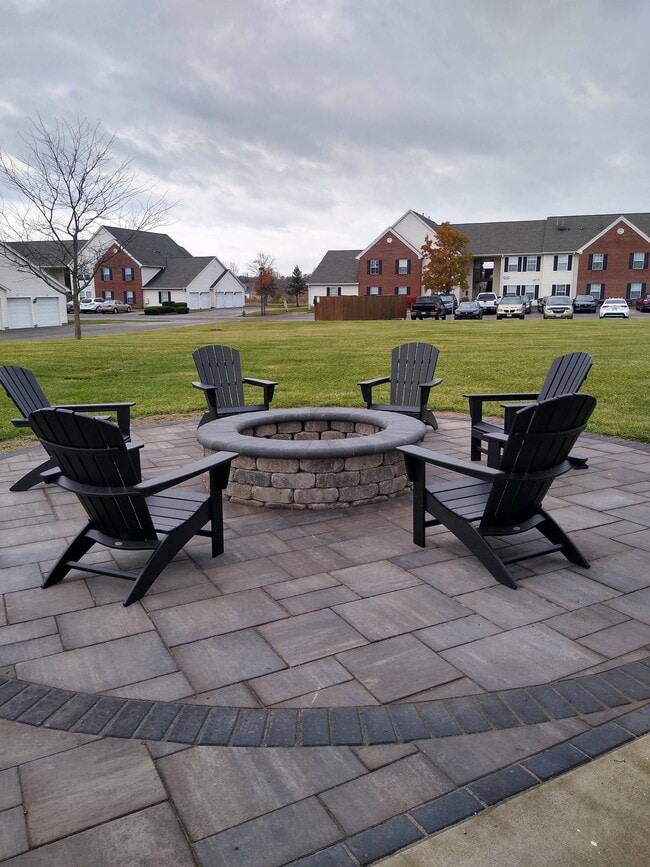 Relax and unwind at our outdoor fireside lounge. - The Links Apartments