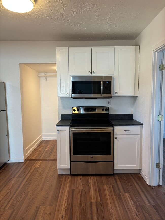 Newly refreshed kitchen with stainless steel appliances and white shaker style cabinetry - 1725 S 35th St