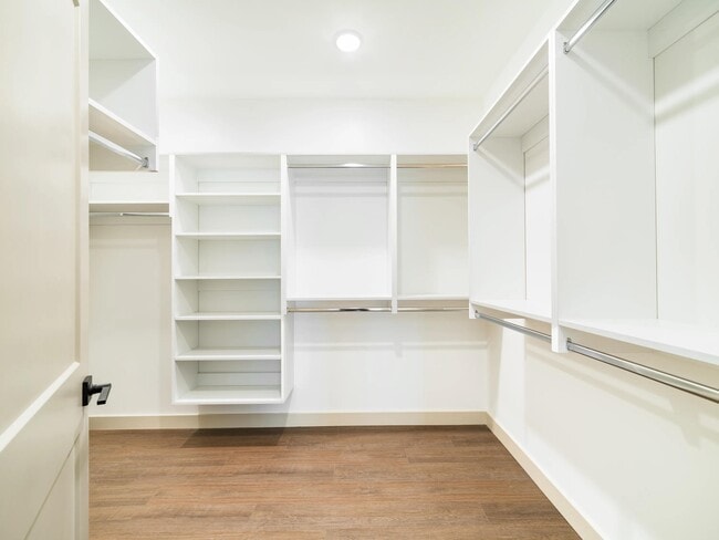 Oversized closet with built-in shelving, multiple hanging areas, and generous storage designed to keep everyday essentials neatly organized.