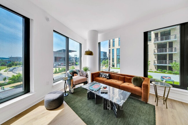 Open-concept living room with spacious size and large windows.