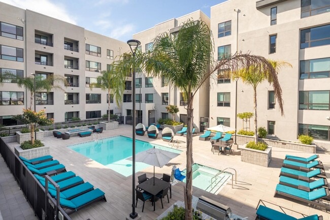 Sunny pool deck with cabanas, daybeds, and plenty of space for relaxed downtime.