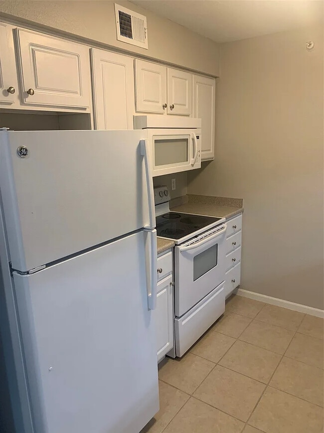 Kitchen with included appliances. - 105 NW 8th St Unit 205