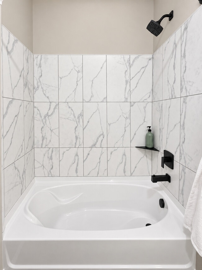 Oversized Bathtub with Tile Surround and Headrest