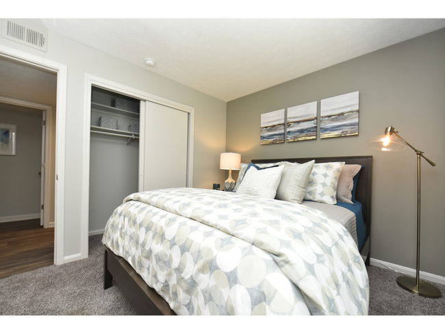 Cozy bedroom with carpet and generous closet space