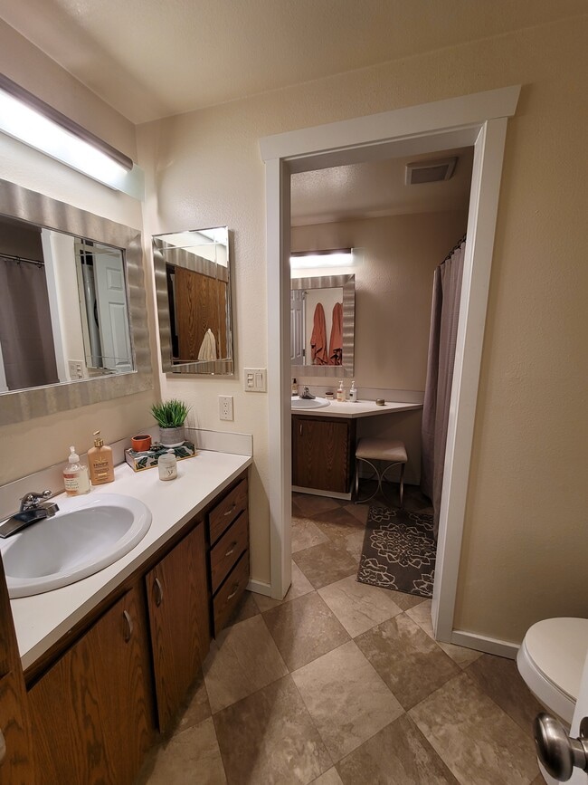 Full bathroom with two vanities, shower, tub, toilet, and laundry - 15707 4th Ave S Unit 23