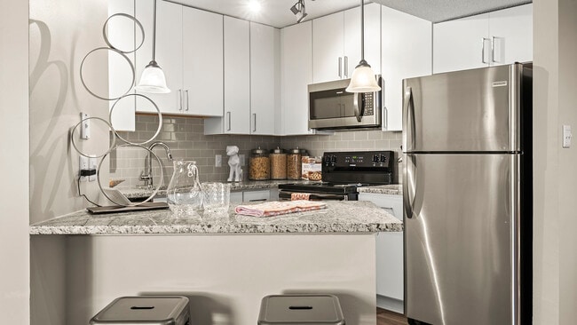 Modern kitchen with sleek finishes and stainless steel appliances