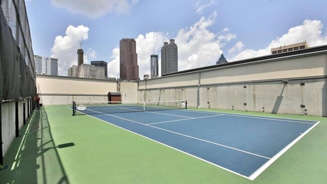 Rooftop tennis court with downtown skyline views