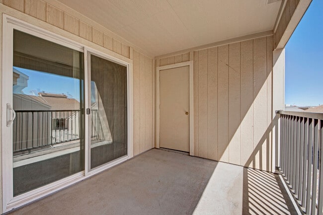 A large balcony with additional storage and a sliding glass door leading to the living room - Fairgreen