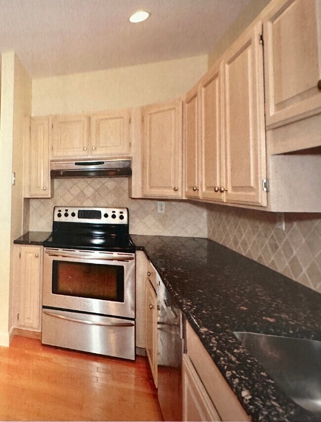 Kitchen w/ new fridge and washer dryer - 100 Keyes Rd Condo Unit #211