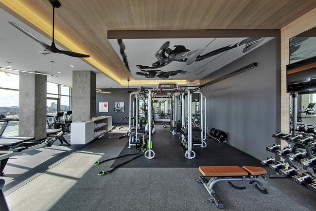 State-of-the-art gym with modern fitness equipment and expansive city views.