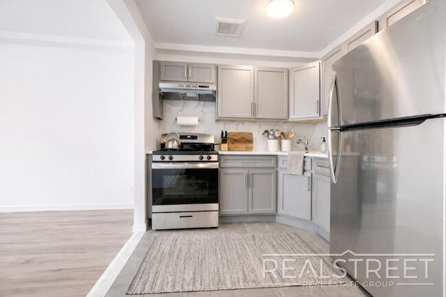 Photo - Full-Floor Renovated 2BR | Expansive Living Space | 1 Min to A Train Unit 3