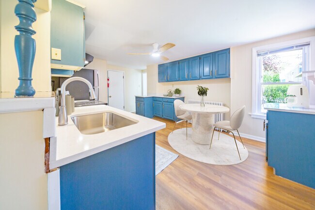 Kitchen with brand new stone countertops, sink & faucet - digitally staged - 47 Pitkin St