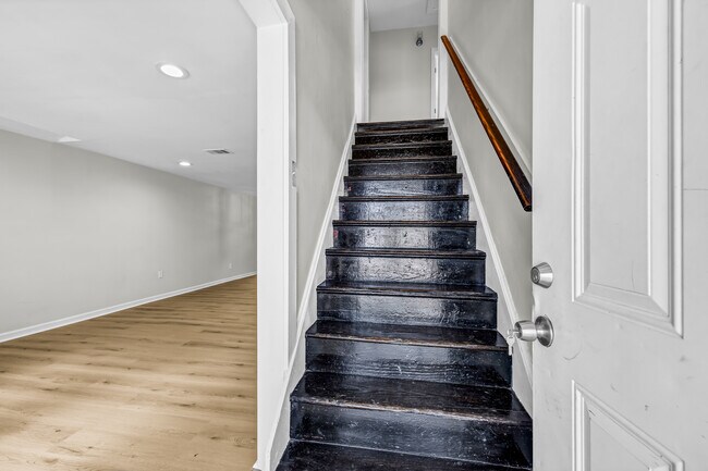 Upon entering, head up the original hardwood stairs, or into the living room.