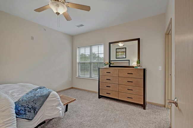 Large Bedroom with Natural Light and Ceiling Fan - Swan Creek Apartments