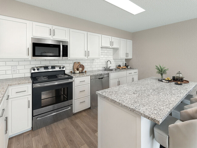 Kitchen with granite counters, stainless appliances, and modern cabinetry