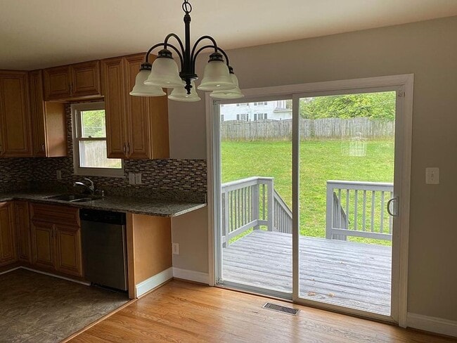 Photo - Spacious 5BR/2BA Single Family | Fresh Paint + New Carpet | New Kitchen Floor | Huge Yard + Deck