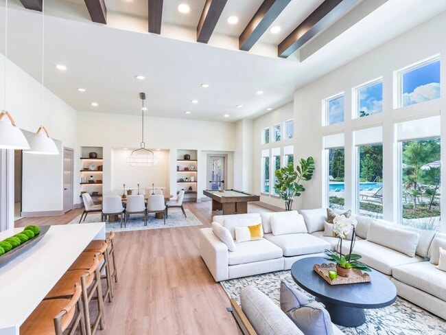 Expansive clubroom with gathering space, lounge seating, and billiards. - Beckett West Fork Apartments