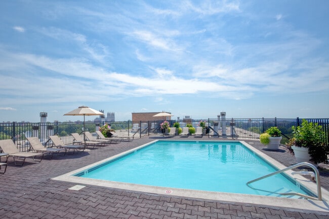 Rooftop pool and sundeck with lounge seating - Avalon at Foxhall Apartments