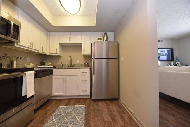 Kitchen with stainless steel appliances, modern cabinetry, and hardwood-style flooring