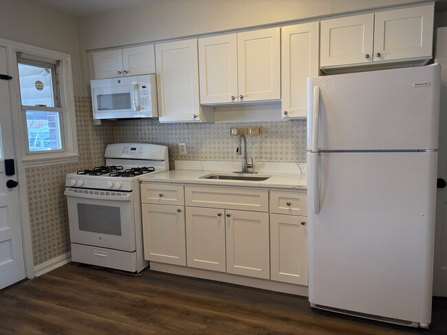 Brand new kitchen! New cabinets, quartz countertop, stove and microwave! - 7125 Gough St Townhome