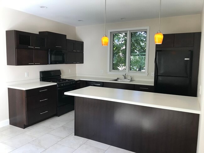 Kitchen with island - 28 Munjoy St Townhome