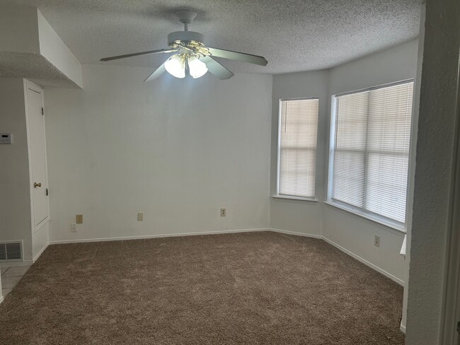 Living room with ceiling fan new carpet and paint - 1345 Trudy Elaine Dr Unit C