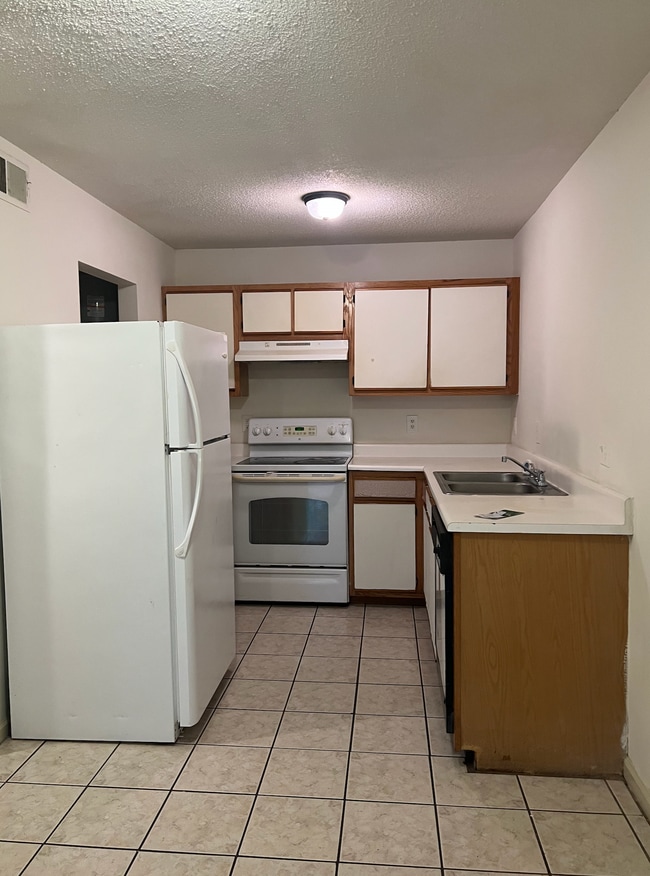 Kitchen with refrigerator, dishwasher and stove - 145 Lullwater Dr Unit 102